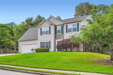View of front of house with driveway, an attached 