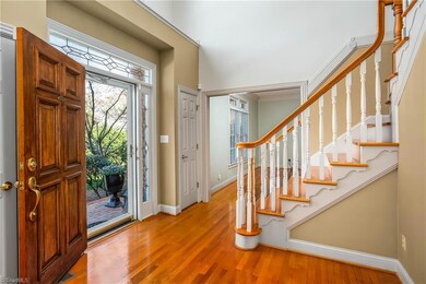 Two story foyer with exposed staircase