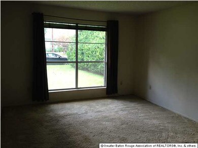 Den with large picture window