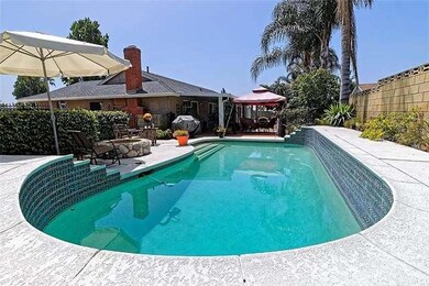 Backside of pool with view of patio area.
