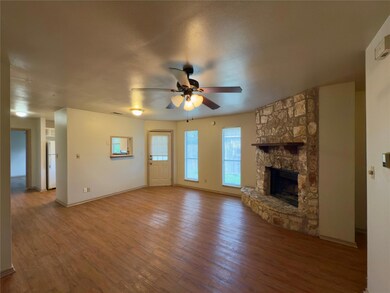 Unfurnished living room with baseboards, a firepl