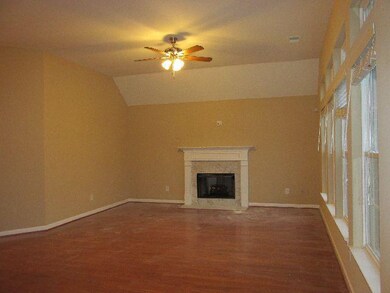 The Living Room has lots of windows and a gas fireplace. Hardwoods have dust on them...new photo will replace.