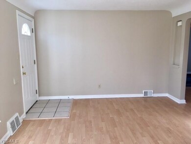 Freshly painted living room with newer front door