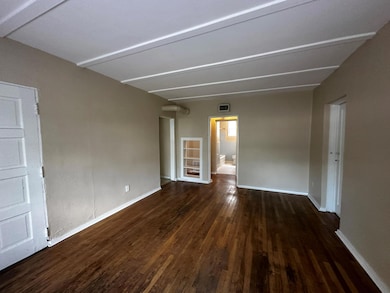 Empty room with wood finished floors and baseboar