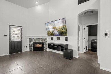 Unfurnished living room featuring a towering ceil