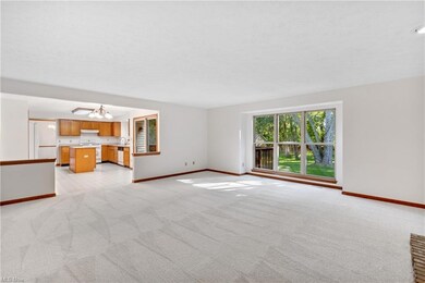 Carpeted spare room featuring separate washer and 