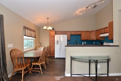 Open-concept kitchen with dinette and decorative l