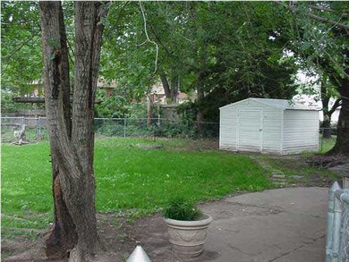 Fenced Yard with Mature Trees and Storage Shed