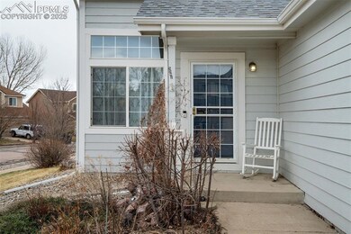Entrance to property featuring a shingled roof