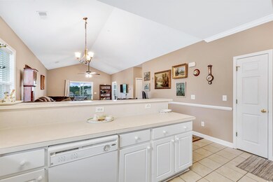 Kitchen with white cabinetry, light tile patterned