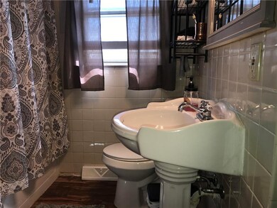 Hall full bath is shower over whirlpool tub.  Newer commode and pedestal sink.