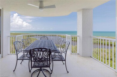 Balcony with a water view, ceiling fan, and outdoor dining space