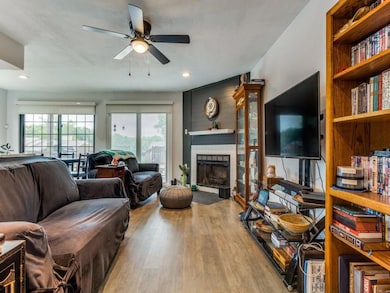 Living room with ceiling fan, recessed lighting, a