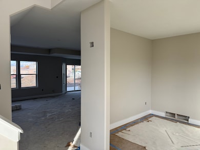 Spare room featuring baseboards and carpet