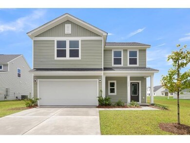View of front of home featuring a garage, central 