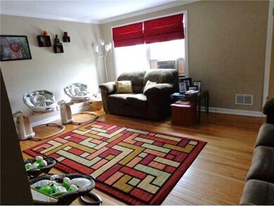 Living Room. Refurbished hardwood floors in roomy 