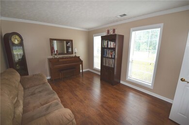 Living room/study with new hardwood flooring. Loca