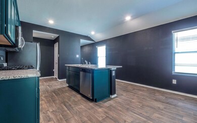 Kitchen with stainless steel dishwasher, an islan