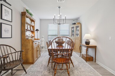 Dining room featuring a chandelier and light wood-type flooring