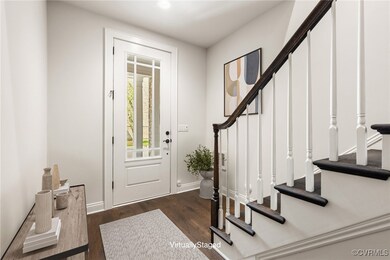 Foyer with stairway, wood finished floors, and bas