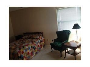 Please don't let this photo fool you, this is a lovely and spacious master bedroom.