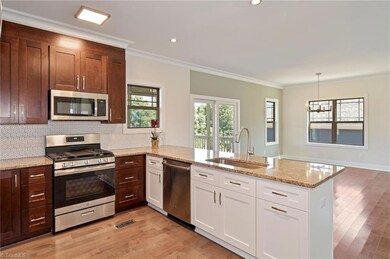 Two tone kitchen with granite countertops and a long breakfast bar
