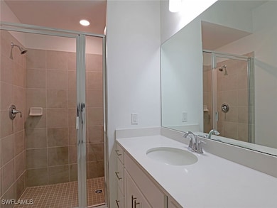 Full bath with vanity, a stall shower, and recesse