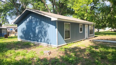 View of side of property featuring roof with shingles