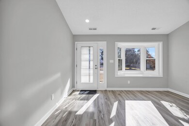 Foyer entrance featuring light hardwood / wood-sty