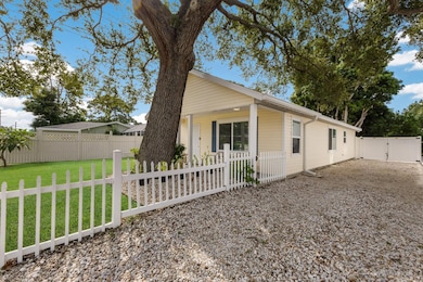 Vinyl fenced yard w/ cute picket fence around the front of the home