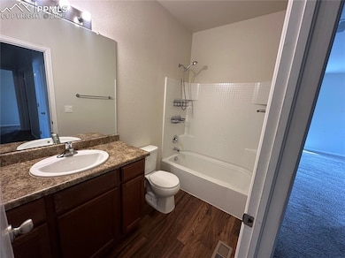 Bathroom featuring vanity, toilet, bathtub / showe