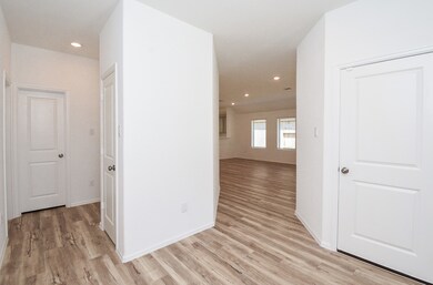 Secondary bedrooms to the left and to the right you will flow into the open floor plan of the living space and kitchen.