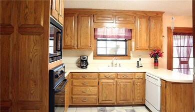 The window over the sink in the kitchen takes advantage of the scenic view into the backyard.  