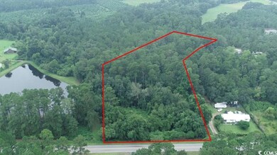 Aerial view of property and surrounding area featuring a large body of water and property boundaries highlighted