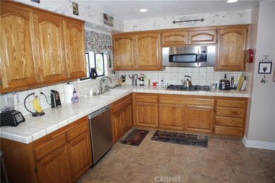 Large kitchen with a 5 burner range, and tons of storage space.