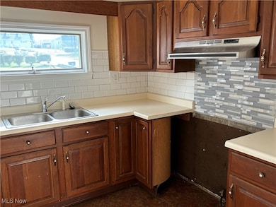 Kitchen featuring sink and backsplash