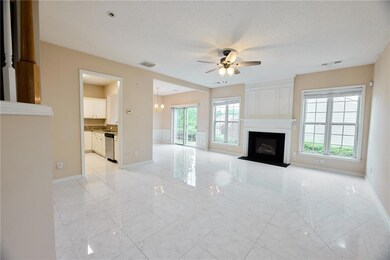 Unfurnished living room featuring ceiling fan, hea