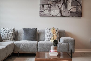 Living area with baseboards and wood finished flo