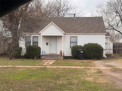 View of front of property with a shingled roof and a front yard