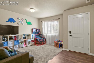 Playroom with wood finished floors and a textured ceiling
