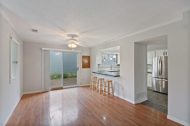Wide shot of dining area, kitchen on the right
