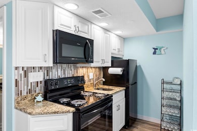 Kitchen featuring sink, light stone counters, deco