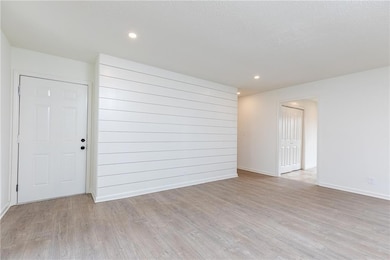 Living room with new flooring and paint, stone fir