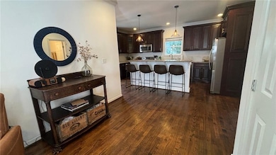 Gleaming floors and living space open to the kitch