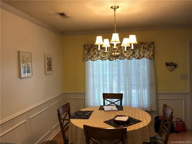 Detailed dining room with crown molding.