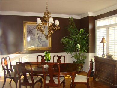 Formal Dining Room with Hardwood Floors, Chair rail & wains coating.