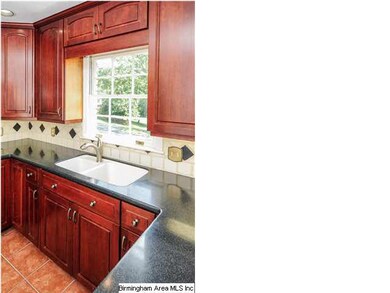 Sunny kitchen has tumbled tile decorative backspla