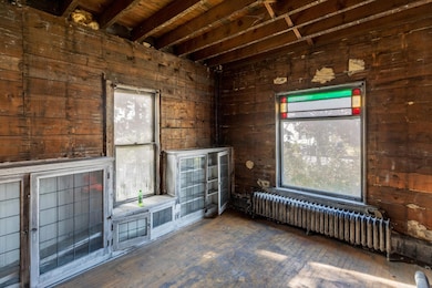 Living room with built-ins and stained-glass window.