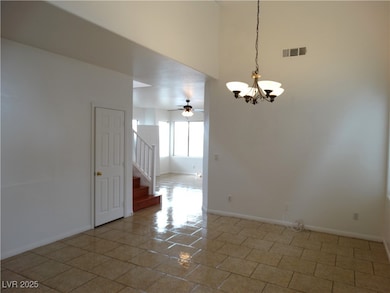 Tiled spare room featuring baseboards, visible ven
