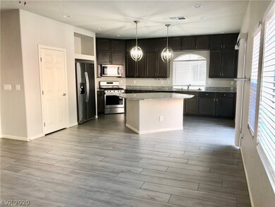 Kitchen opens up to the large family room for an o
